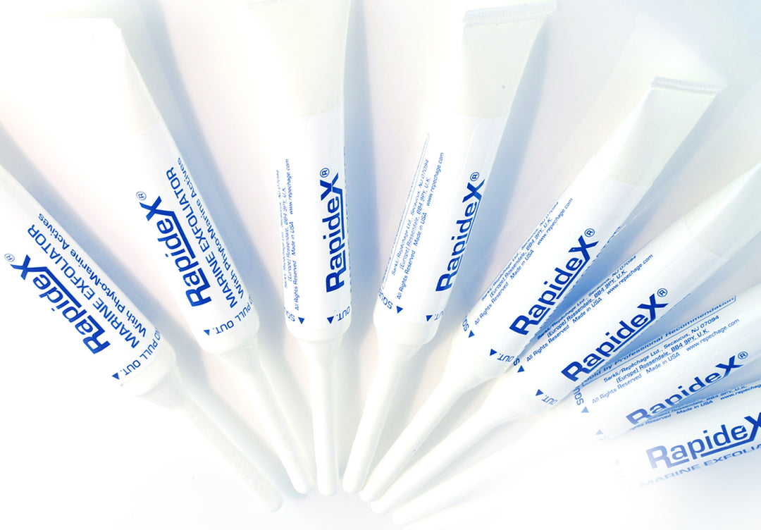 Eight Rapidex Marine Exfoliator Tubes laying in a row